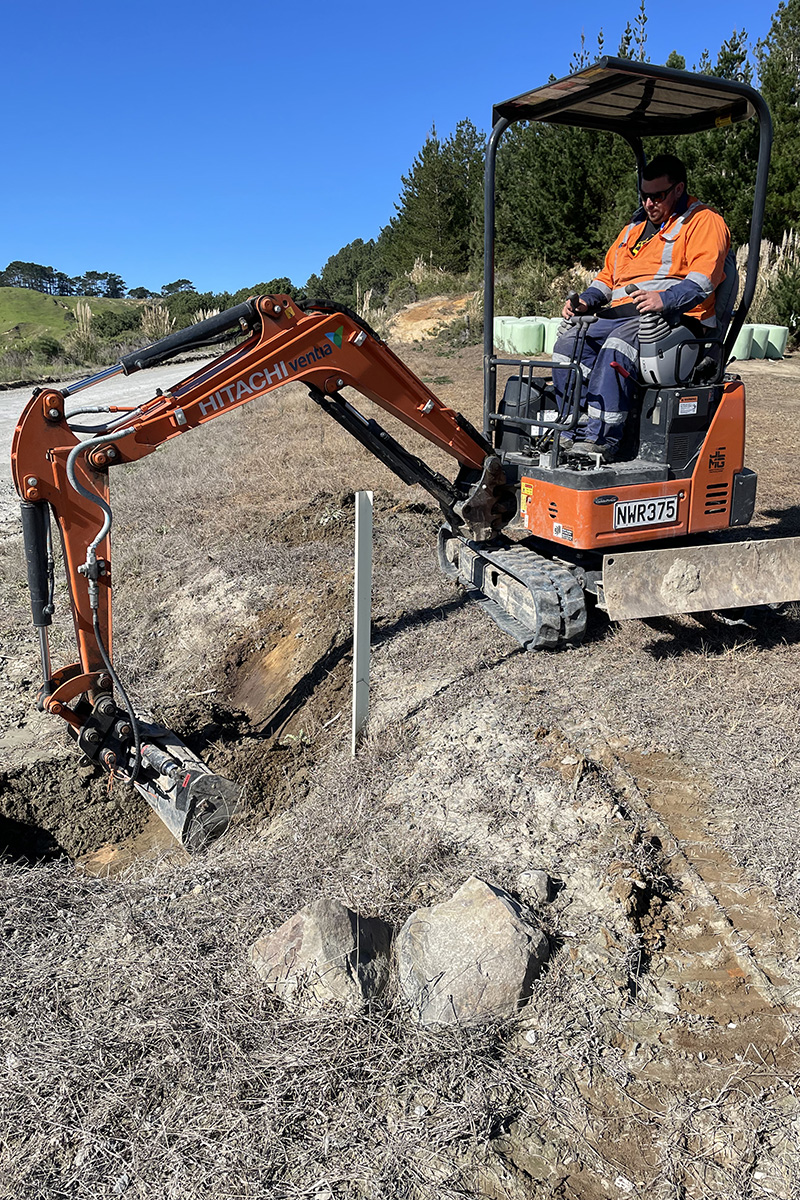 Person on a digger clearing a culvert.